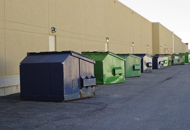 a yellow construction dumpster filled with waste materials in Aragon, GA